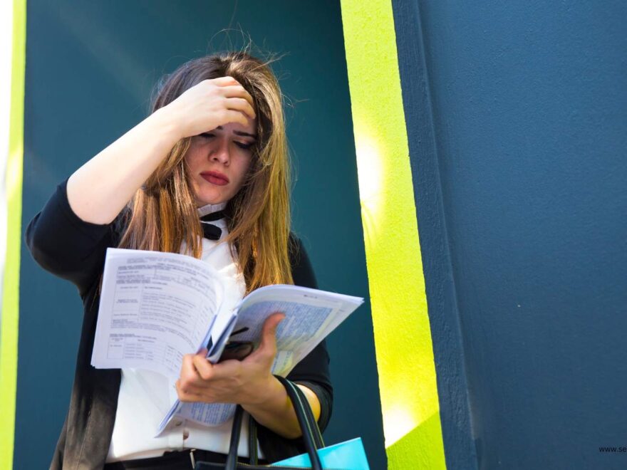 Anxious women reading papers